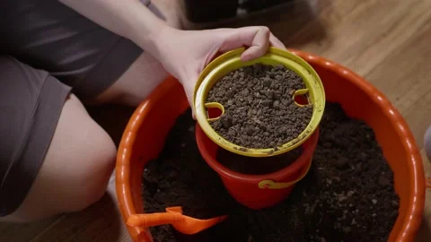 Close up woman sifting compost through a sieve to create a soil mixture Stock Footage 236689253