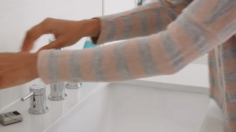 Close Up Of Woman Squeezing Toothpaste Onto Toothbrush In Bathroom Stock Footage 111971318