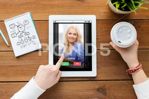 Close up of woman with tablet pc on wooden table Stock Photos