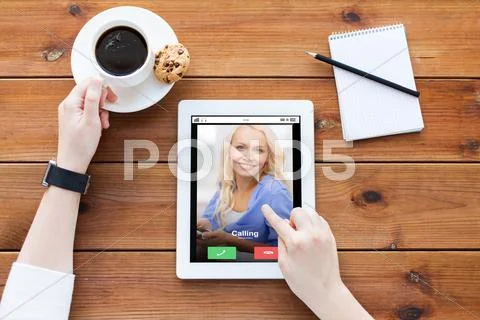 Close up of woman with tablet pc on wooden table Stock Photos