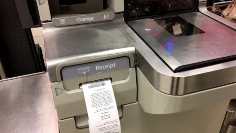 Close up of woman taking receipt at self-check out counter Stock Footage 72663043