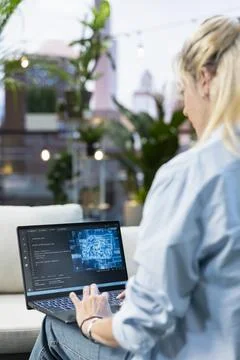 Close up of woman typing source code with artificial intelligence on laptop Stock Photos