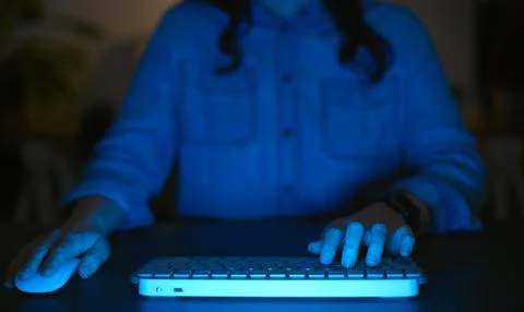 Close Up Of Woman Using Computer At Home At Night With Fingers Typing On Stock Photos