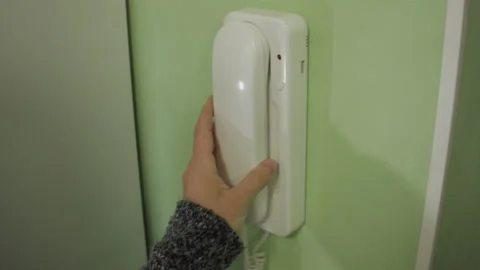 Close-up of a woman using an intercom at home Video stock 137810427