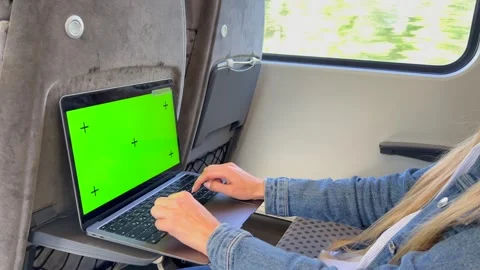 Close-up of a woman using a laptop while traveling on a train. Chromakey screen Stock Footage 253174653