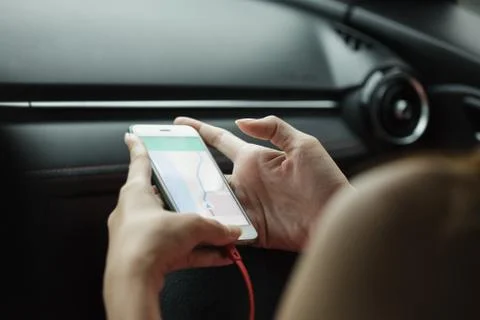 Close-up woman using map app on phone mobile Stock Photos