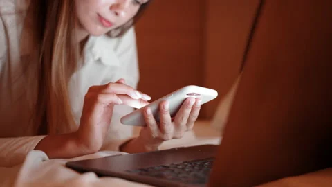 Close up of woman using mobile and laptop at hotel room Stock Footage 164983335