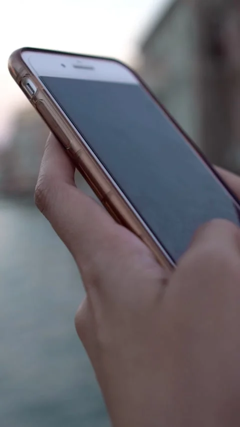 Close up woman using mobile phone with Basilica Santa Maria della Salute Stock Footage 328174494