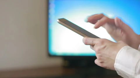 Close up of a woman using mobile smart phone. the background monitor Stock Footage 68995359
