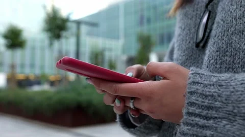 Close up of a woman using mobile smart phone in city street Stock Footage 236868706