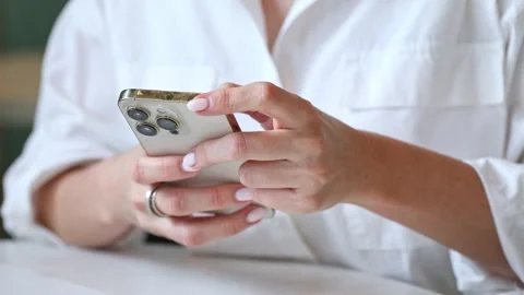 Close up woman using mobile smartphone, writing a message, surfing the internet Stock Footage 302155762