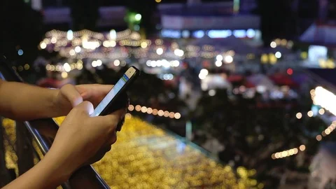 Close up woman using scrolling social media app on mobile phone, night city Stock Footage 108326667