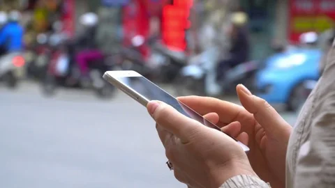 Close-Up Woman Using Smart-Phone In The City.The brisk road on a background Stock Footage