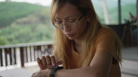 Close Up Of Woman Using Smart Watch Sitting At Table In Cafe Stock Footage 198296496