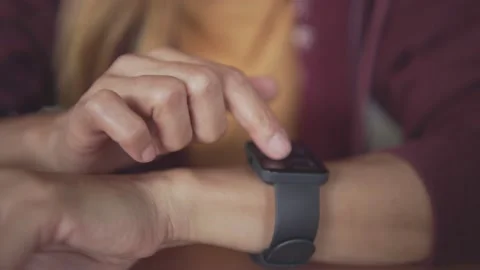 Close Up Of Woman Using Smart Watch Sitting At Table In Cafe Stock Footage 198296801
