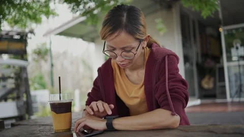 Close Up Of Woman Using Smart Watch Sitting At Table In Cafe Stock Footage 198296979