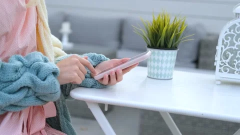 Close-up of a woman using a smartphone while sitting in a street cafe Stock Footage 200828086