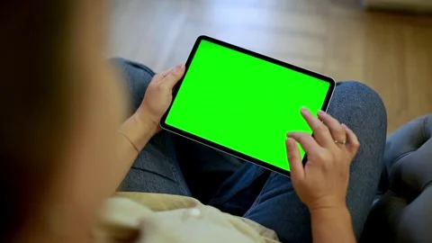 Close-up of woman using tablet with green screen at home Stock Footage 300981203
