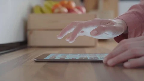 Close up of woman using tablet over kitchen counter in her kitchen. Stock Footage 128069836