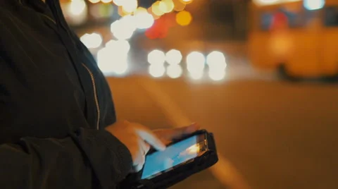 Close-up of woman using tablet pc outdoors in the city at night. Stock Footage 68632872
