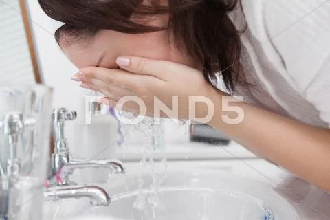 Close-up of woman washing face Stock-Fotos