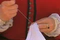 Close up of woman wearing historical dress and sewing Footage