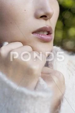 Close up of a woman wearing a white jumper Stock Photos