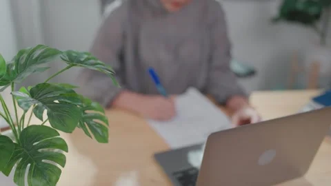 Close-up of woman working with documents at office, paying utility bill using la Stock Footage 276724283