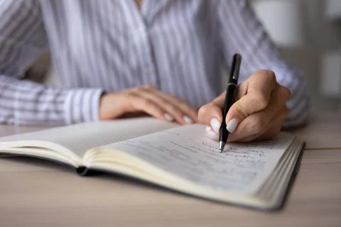 Close up of woman write make notes in notebook Stock Photos