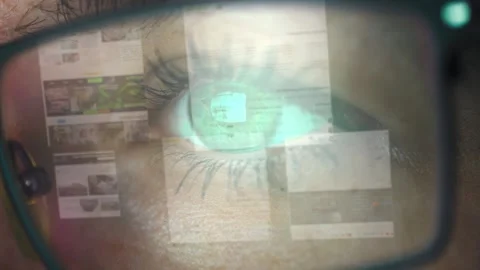 Close-up of a woman's eye with glasses. Reflection of web pages in the lenses of Stock Footage 271357364