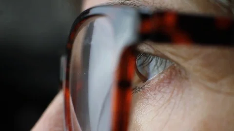 Close up of a woman's eye while reading Stock Footage 70324925
