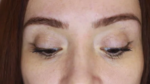 Close-up of a woman's eyes looking at the camera, looking down and up Stock Footage 281328232
