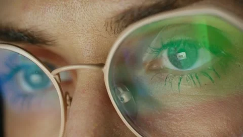 Close up of woman's eyes with screen reflection in glasses Stock Footage 337830373