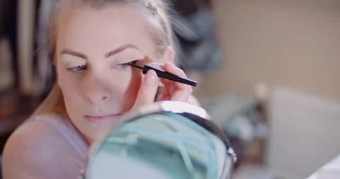 Close up of woman's face applying makeup Stock Footage 305058288