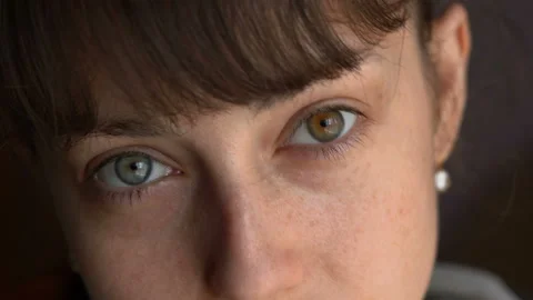 Close up of woman's face, beautiful blue and brown eyes, portrait, heterochromia Stock Footage 127133904