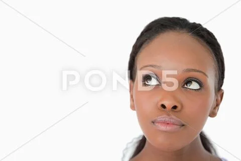 Close up of woman's face looking upwards diagonally on white background Stock-Fotos