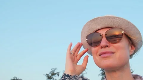 Close-up of a woman's face, she is admiring the sunset on the sea. Stockbeeldmateriaal 237601461