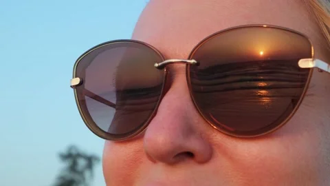 Close-up of a woman's face, she is admiring the sunset on the sea. Stock Footage 237709517