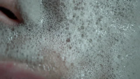 Close-up of a woman's face smeared with a carbonated bubble clay mask Stock Footage 143873141