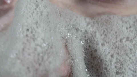 Close-up of a woman's face smeared with a carbonated bubble clay mask Stock Footage 143873512