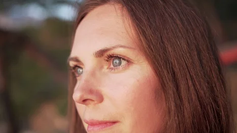 Close up of woman's face at sunset, beautiful green eyes, portrait Stock Footage 124715421