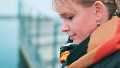 Close up of womans face while she looks down on her phone Stock Footage 122257850