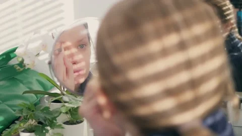 Close-up of a woman's face. woman doing makeup while sitting in front of a Stock Footage 191496853