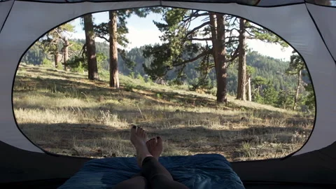 Close-up of a woman's feet crossing while relaxing in her tent Stock Footage 138475412