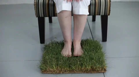 Close up of woman's feet on patch of grass Stock Footage 32716261