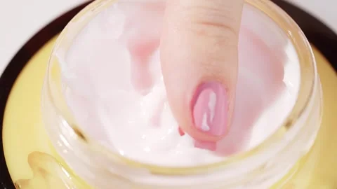 Close-up of a womans finger gently taking face cream from a glass jar. Skin.. Stock Footage 315032787