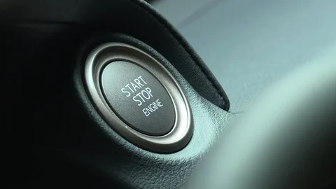 Close up on woman's finger pressing start engine button in car Stock Footage 123884244