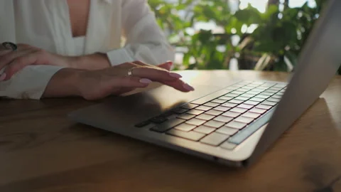 Close-up of a woman's finger use touchpad of a laptop in a cafe, makes a search Stock Footage 168493227