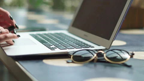 Close up of womans fingers typing on the computer keyboard. Background glasses Stock Footage 195875879