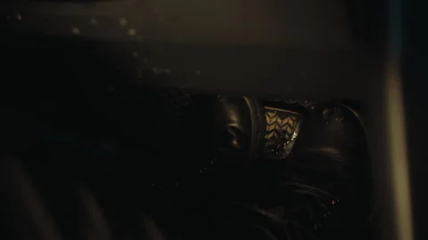Close-up of a woman's foot in a boot presses the brake pedal in a car at night Vídeo Stock 249669085